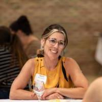 Educator smiles at GVSU Education Alumni Network teacher and mentor appreciation night